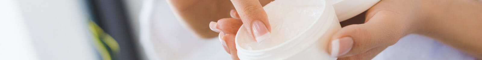 Woman using face cream