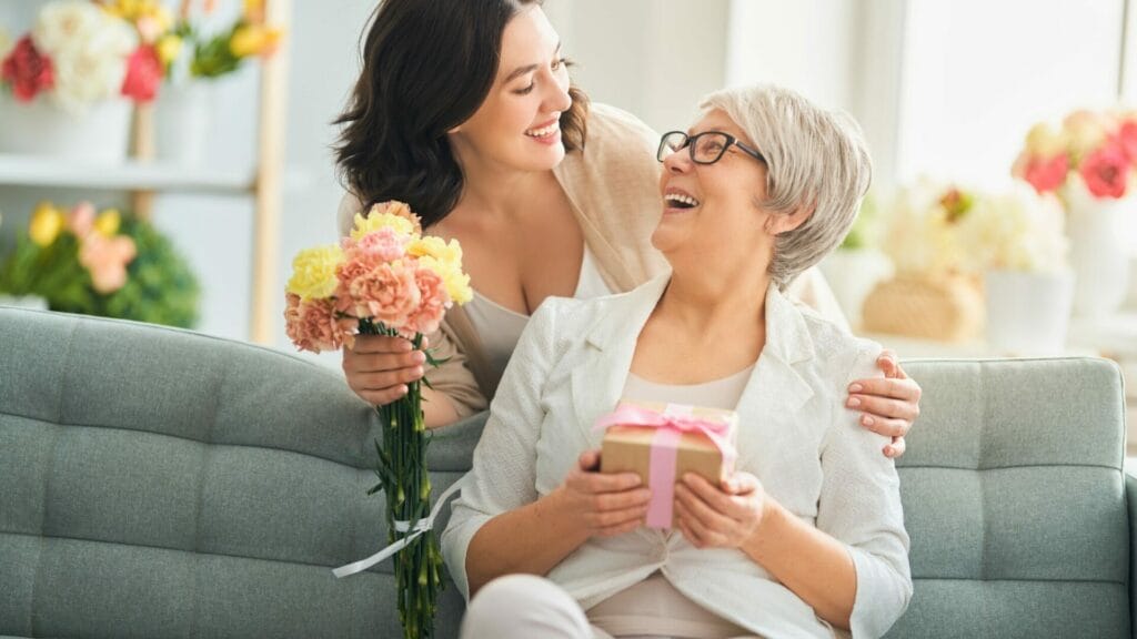 A mum giving flowers to their mum on Mothers Day